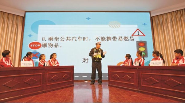 交警向?qū)W生解答交通安全知識(shí)競(jìng)答題